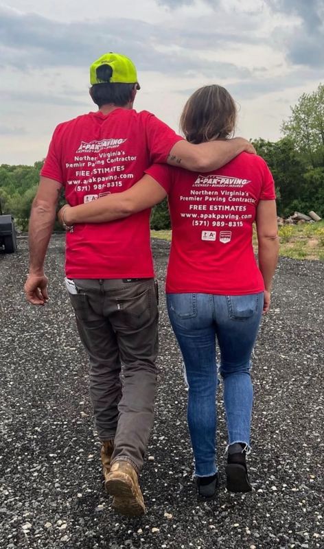 Rebecca and Neil, owners of A-Pak Paving, walking a freshly prepared driveway in their A-Pak crew shirts